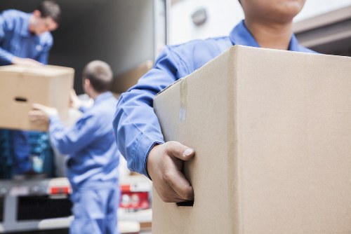 Office relocation planning in Greenwich with moving team and packed boxes