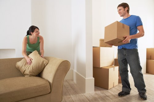 Professional movers carrying furniture in a Greenwich street